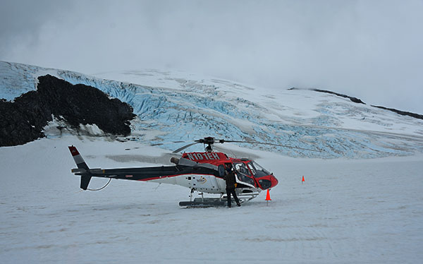 helicopter lands on glacier